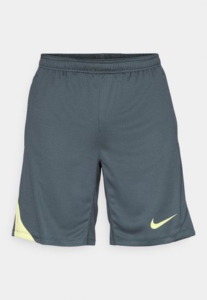 Sötétszürke Nike sportnadrág, texturált anyagból, neon sárga logóval az alján, jobb oldalon. Rugalmas derékpánt a megfelelő illeszkedés érdekében.