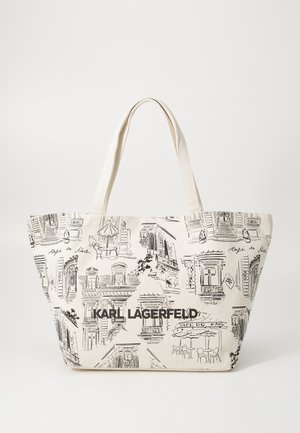 Beige Jutetasche aus Baumwolle mit schwarzen Skizzen von Gebäuden und Café-Szenen. "KARL LAGERFELD" groß auf der Vorderseite aufgedruckt.