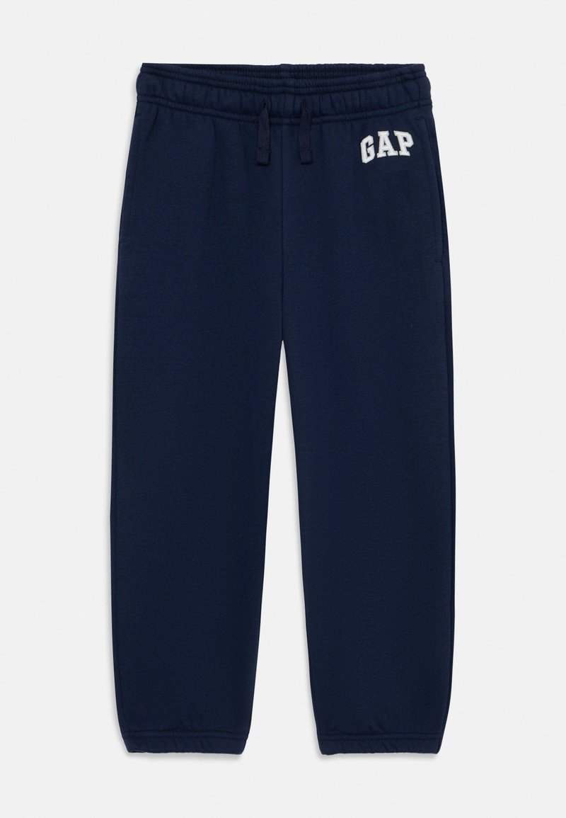 Laivansiniset collegehousut, joissa on elastinen vyötärö, nyöri ja valkoisella kirjailtu "GAP"-logo. Pehmeä kangas ja rento istuvuus.