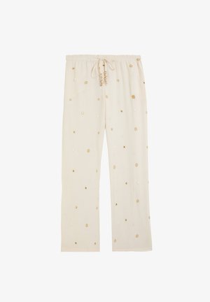 Pantalones holgados de color crema con cintura elástica y bordado floral dorado disperso por toda la tela.