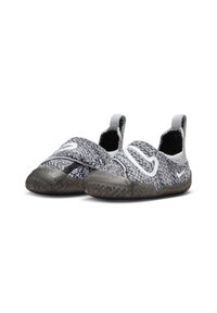 Zapatillas deportivas en negro y gris con una parte superior de tejido texturizado, bandas elásticas y suela de goma. Cuenta con un acento de logo blanco en el lateral.