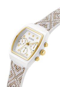 Montre rectangulaire blanche avec des accents dorés, trois sous-cadrans, et un bracelet texturé beige et blanc. Présente des marqueurs ressemblant à des diamants sur le cadran.