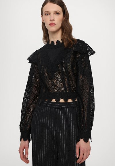 Black lace top with long puff sleeves and scalloped neckline. Features floral patterns, a cropped fit, and intricate lace trim.