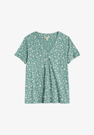 Maglietta verde a maniche corte con scollo a V, con piccola stampa floreale e foglie bianche, dettaglio di pieghe raccolte sotto lo scollo e etichetta del marchio Seasalt.