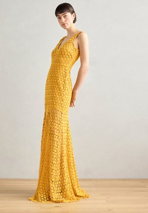 Yellow lace maxi dress with a V-neck and sleeveless design, featuring a floral pattern and flared hem. Textured, lightweight material.