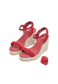 Red suede wedge sandals with a jute-wrapped midsole, adjustable ankle strap, flat toe band, and matching fabric ribbon for styling.