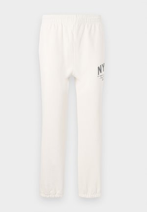 White cotton sweatpants with an elasticated waistband, featuring "NY" print on the left thigh and elastic cuffs at the ankles.