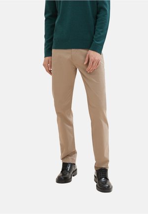Beige cotton trousers with straight cut. Worn with a green sweater and black leather shoes. Smooth texture, minimal detailing, and no patterns.