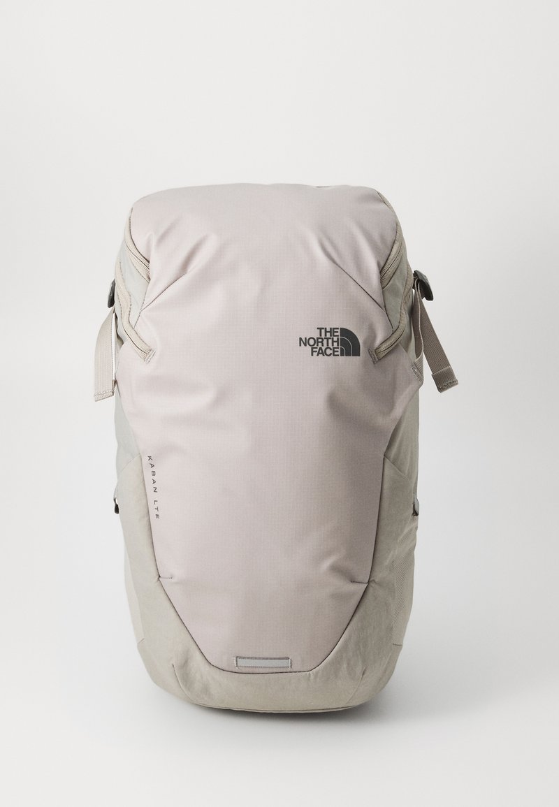Light gray backpack made from durable fabric with smooth texture. Features a logo, adjustable straps, and multiple compartment zippers.