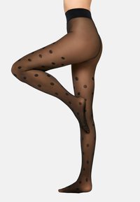 Czarne rajstopy w groszki z półprzezroczystym wykończeniem i jednolitym paskiem w talii, prezentujące dopasowany krój i gładką fakturę. Akcentowane dużymi kropkami.