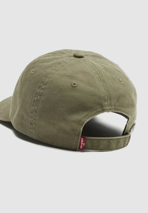 Olive green adjustable baseball cap with fabric strap and metal buckle, featuring a small red Levi’s logo tag at the back.