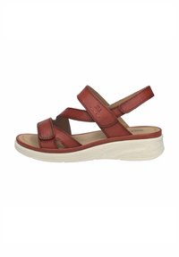 Sandale en cuir marron à bout ouvert avec des sangles ajustables et une semelle blanche rembourrée, conçue pour le confort et un usage décontracté.