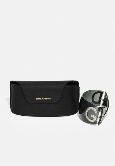 Black textured sunglasses case with a magnetic closure, alongside black sunglasses featuring a large letter 'G' adorned with rhinestones.