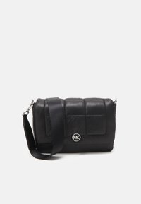 Borsa a tracolla nera trapuntata in nylon, con spallaccio e hardware silver, dotata di un logo circolare MK sul davanti.