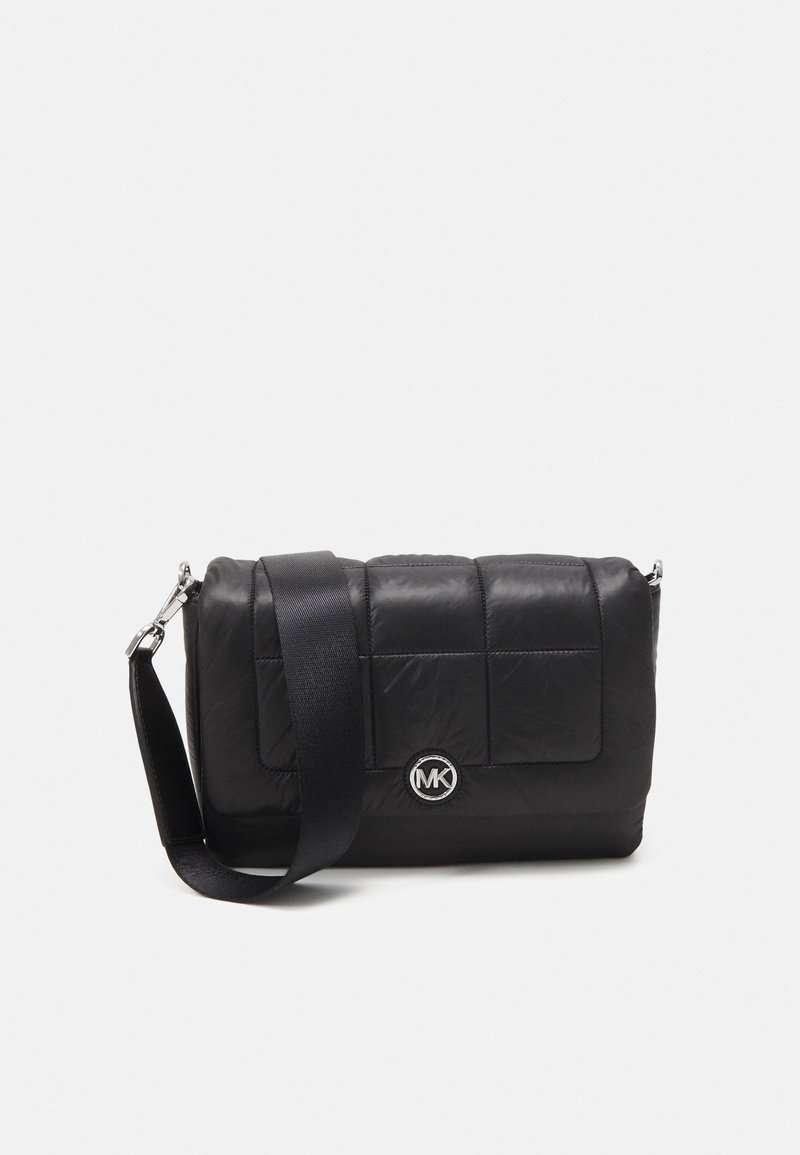 Black quilted crossbody bag made of nylon, featuring a shoulder strap and silver hardware with a circular MK logo on the front.