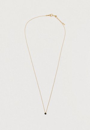 Delicate gold chain necklace with small black circular pendant and a spring ring clasp on a light background.