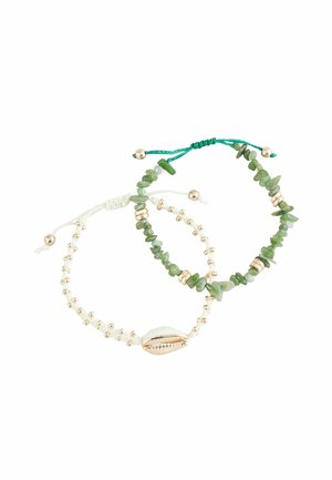 Two adjustable bracelets: one features green gemstones and gold accents, the other has white beads and a seashell charm.