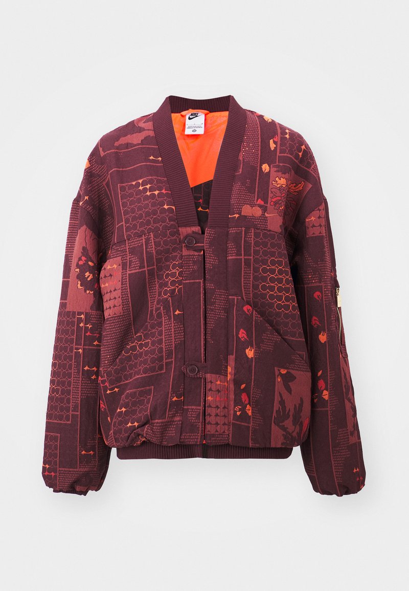 Bordeauxfarbene Jacke mit grafischen Mustern in Orange und Rot, mit geripptem Kragen, Knopfverschluss und elastischen Bündchen. Reißverschluss-Tasche am Ärmel.