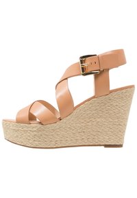 Sandalias de cuña de cuero marrón con correas entrelazadas, una hebilla dorada y un tacón de cuña envuelto en yute. Textura suave con un acabado natural.