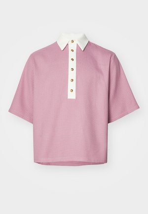 Short-sleeve polo shirt in pink with a textured pattern, white collar, and gold buttons down the front. Casual, loose fit design.