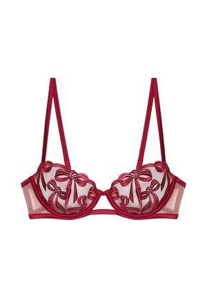 Soutien-gorge rouge brodé avec des bonnets transparents, présentant des motifs de nœuds et des bretelles en satin. Le soutien-gorge avec armatures et une texture lisse mettent en valeur le design.