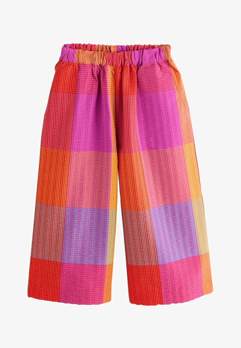 Pantalon à jambes larges avec ceinture élastique, présentant un grand motif à carreaux colorés en nuances de rouge, rose, orange, violet et jaune.