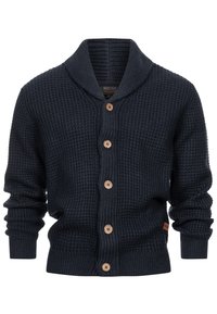 Cárdigan de punto en color marino con cuello de chal, botones de madera y puños acanalados. Tejido texturizado con un diseño cálido y acogedor.