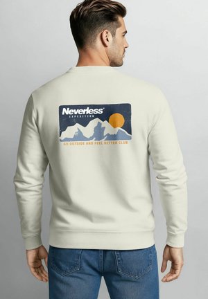 Light beige sweatshirt with a rectangular graphic featuring mountains, a sun, and the text "Neverless Expedition" in blue and orange.