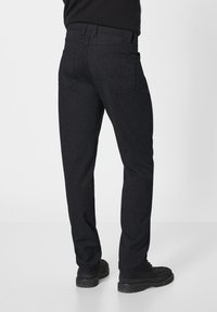 Dark gray trousers made of textured fabric, featuring a straight-leg design, two back pockets, and a standard waistband.