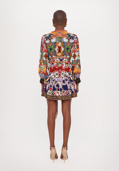 Colorful patterned dress featuring long sleeves, a fitted waist, and a flared skirt. Material appears lightweight with intricate designs.