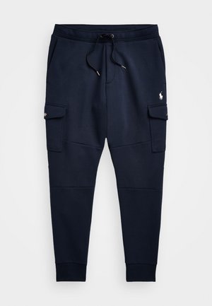 Jūras spēku sporta bikses, kas izgatavotas no kokvilnas maisījuma, ar aukliņu jostasvietā, divām sānu kabatām un mazu logo kreisajā augšstilbā.