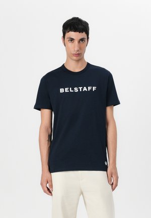 Navy blue cotton t-shirt with short sleeves and a crew neck. Features white "BELSTAFF" logo on the front. Smooth texture, casual fit.