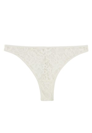 Perizoma bianco in pizzo con motivo floreale e chiusura sottile su sfondo semplice.