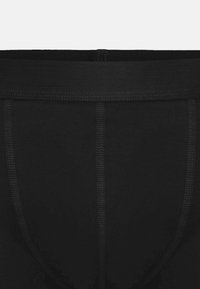 Zwarte katoenen onderbroek met een naadloze tailleband, een gladde textuur en een comfortabele pasvorm met contrasterende stiksels langs de zijkanten.