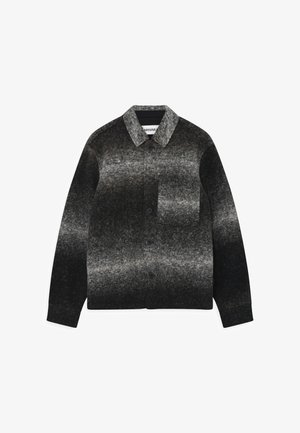 Melna un pelēka gradienta pogājamā krekla jaka, izgatavota no filcētas vilnas, ar apkakli, krūšu kabatu un struktūru virsmu.