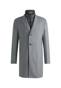 Grå lång kappa med en texturerad yta, slagkrage och ett zip-inre lager. Har två framfickor och en enkel knäppning.