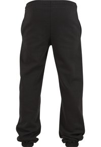 Zwarte sweatpants met een elastische tailleband en omgeslagen zoom. Gemaakt van zacht materiaal, met zijzakken en een gladde textuur.