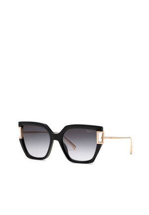 Lunettes de soleil œil de chat noires oversize avec verres dégradés et branches texturées dorées et accents près des charnières.