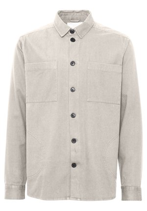 Lys grå bomullsskjorte med knappelukking foran, to brystlommer og klassisk krage. Har svarte knapper og buede sidesømmer.