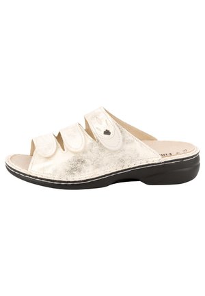 Hvid læder sandal med åben tå, tre justerbare remme og en sort polstret sål for komfort og støtte.