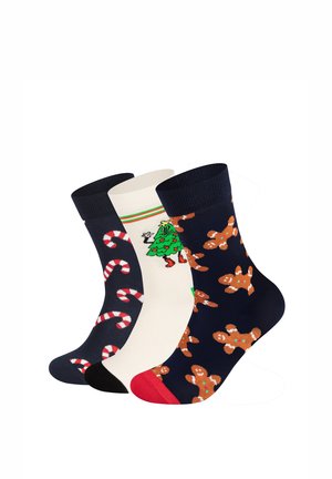 Trois paires de chaussettes festives : bleu marine avec des bonhommes en pain d'épice, crème avec un sapin de Noël vert, et noir avec des motifs de cannes en sucre. Tricot en coton.
