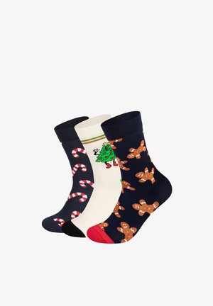 Drei Paare festlicher Socken: navyblau mit Lebkuchenmännern, cremefarben mit einem grünen Weihnachtsbaum und schwarz mit Zuckerstangenmuster. Aus Baumwollstrick.
