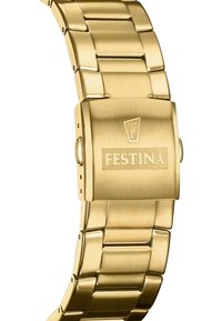 Zelta tonis pulkstenis ar matētu metāla siksniņu, ar taisnstūra korpusu un sprādzi, un iegravētu logotipu uz sprādzes.