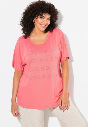 Koraal oversized t-shirt met korte mouwen en een ronde hals, voorzien van een tekstontwerp in zilver. Zachte stof met een ontspannen pasvorm.