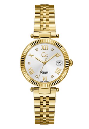 Gold-toned watch with a round silver dial, Roman numerals, crystal accents, and a textured gold bracelet. Displays day and Swiss movement.