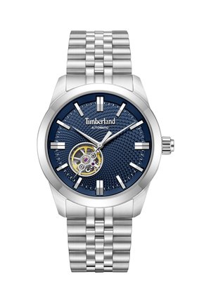 Samodejna ročna ura Timberland iz srebrnega kovinskega materiala z modrim teksturiranim številčnicem, odprtim mehanizmom, srebrnimi označevalci ur in kovinsko zapestnico s povezavami.