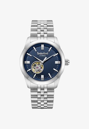 Silver metal Timberland automatic wristwatch with blue textured dial, open heart display, silver hour markers, and linked metal bracelet.