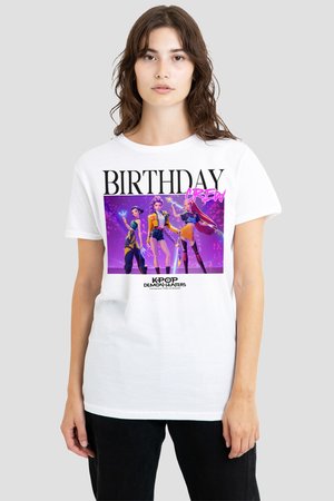 Young woman wearing white t-shirt with colorful animated female characters and text "BIRTHDAY CREW" and "KPOP DEMON HUNTERS."