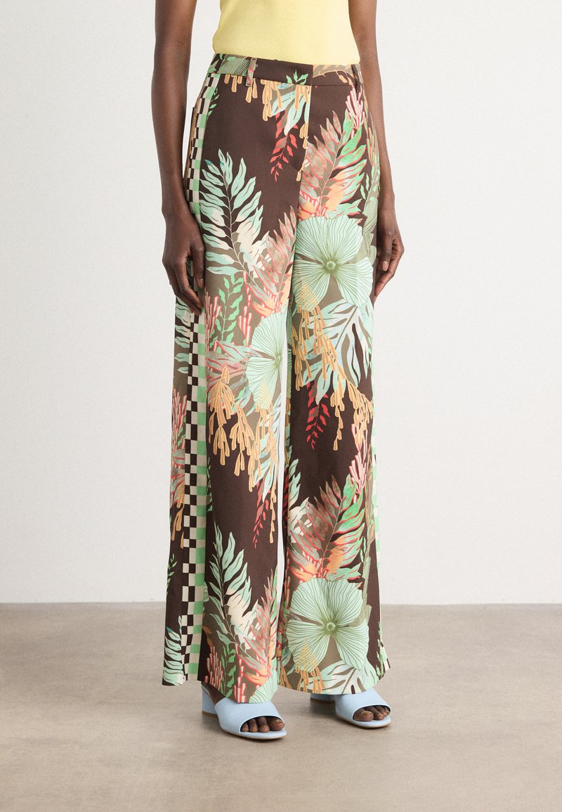 Wide-leg trousers in a brown fabric featuring a vibrant floral pattern with green, pink, and orange leaves, accented by a checkerboard design.