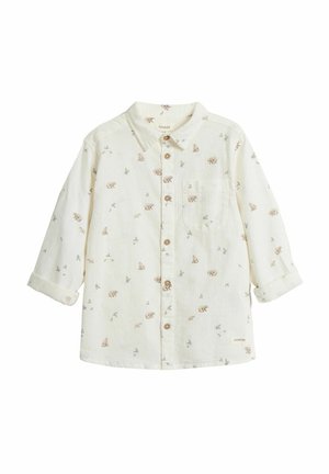 Helle, langärmlige Button-Up-Bluse aus weichem Stoff mit einem Bären- und Pflanzenmuster, Holzknöpfen und einer Brusttasche.